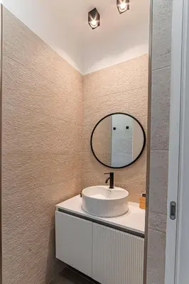 a bathroom with a sink and a mirror at Vatican Suites Apartment - Vatican City in Rome