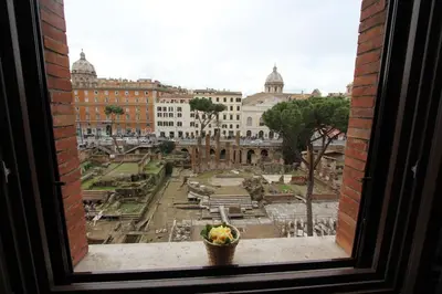 a view of a city from a window at Area Sacra Relais in Rome