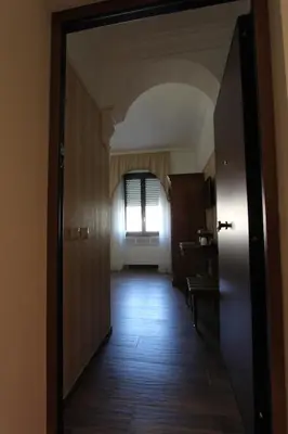 a hallway with a door leading to a room with a window at Area Sacra Relais in Rome