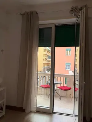 a room with a balcony with a table and chairs at Vatican Family House Metro A - Rome Collection in Rome