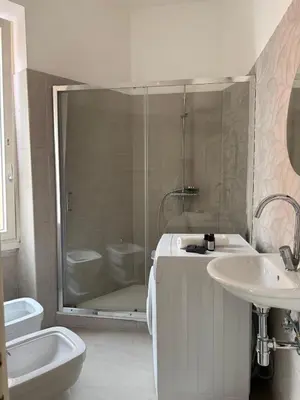 a bathroom with a shower and a sink and a toilet at Vatican Family House Metro A - Rome Collection in Rome