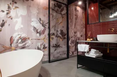 a bathroom with a bath tub and a sink at Maison Ametie in Rome