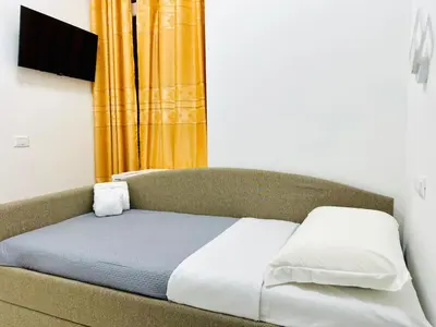 a bed in a room with a yellow curtain at Acropoli in Rome