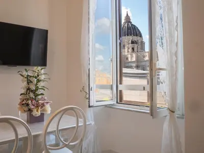 a room with a window with a view of a building at De Camillis Apartments in St Peter in Rome