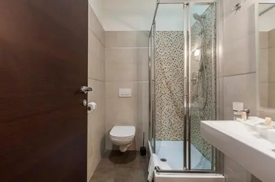a bathroom with a shower and a toilet and a sink at Stardust Rome Guest House in Rome