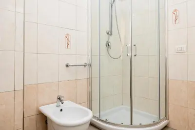 a bathroom with a shower and a toilet and a sink at Vatican Giuliano’s House in Rome