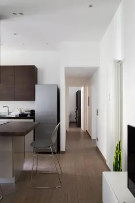 a kitchen with a table and a chair in a room at Casa Simone - The Italian Stay Collection in Rome