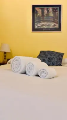 a pile of towels sitting on top of a bed at Historic apartment by the Pantheon in Rome