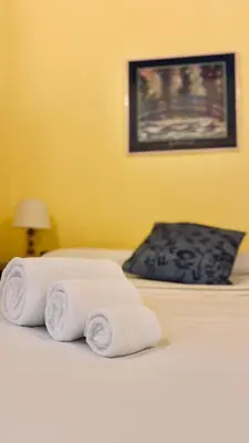 two rolled towels on a bed in a room at Historic apartment by the Pantheon in Rome