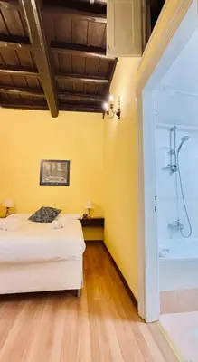 a bedroom with two beds and a shower at Historic apartment by the Pantheon in Rome