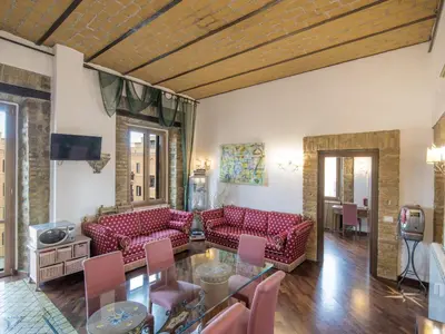 a living room with red couches and a glass table at Apartment Lucilla Home by Interhome in Rome