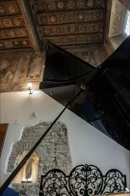 a kitchen with wooden cabinets and a stove top oven at House-Museum Palazzo Podocataro in Rome