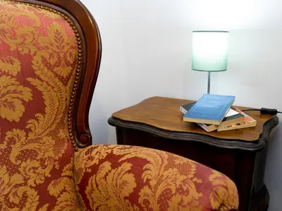 a table with a chair and a laptop on it at Salotto Piramide in Rome