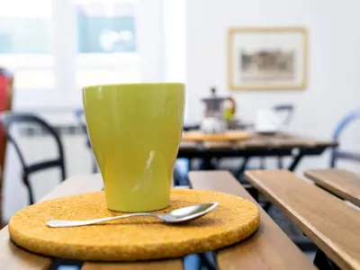 a green cup sitting on top of a table at Salotto Piramide in Rome