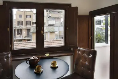 a table with two cups on it in a room with windows at Laurina F2 roof terrace - LOCAPPART in Rome