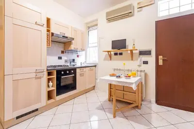 a kitchen with a small table in the middle of it at Casina Roxy in Rome