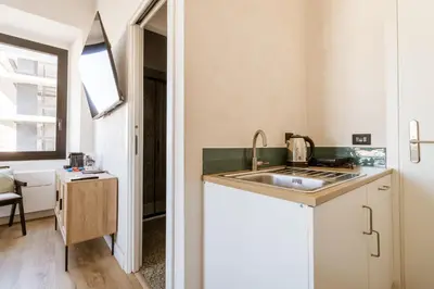 a kitchen with a sink and a counter top at Cunabu Giolitti 12 in Rome