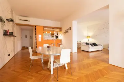 a dining room and living room with a table and chairs at Fontana di Trevi Modern Apartment in Rome
