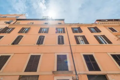 a tall building with many windows on it at Fontana di Trevi Modern Apartment in Rome