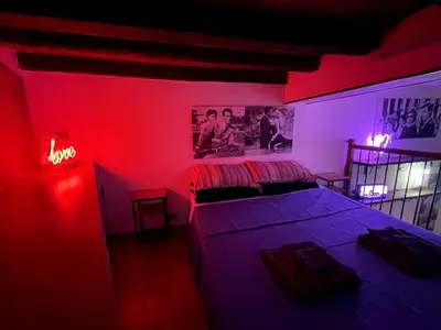 a bedroom with two beds and a red light at Bnb cuore di Roma in Rome
