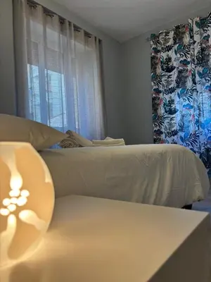 a bedroom with a bed and a couch and a window at MV Vatican House in Rome in Rome