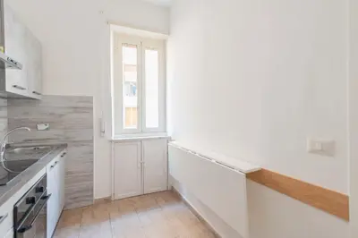 a white kitchen with a sink and a window at MV Vatican House in Rome in Rome