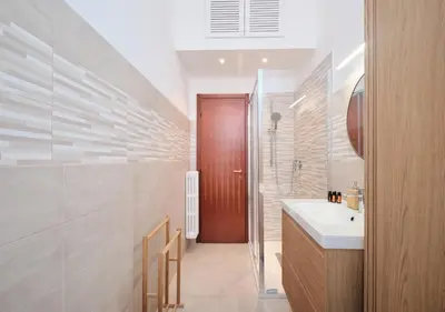 a bathroom with a sink and a shower and a mirror at COLOSSEO a 15 min - Attico con Terrazza in Rome