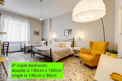 a bedroom with a bed and a table and a chair at BDC - Kingdom 5-BDR in Termini in Rome