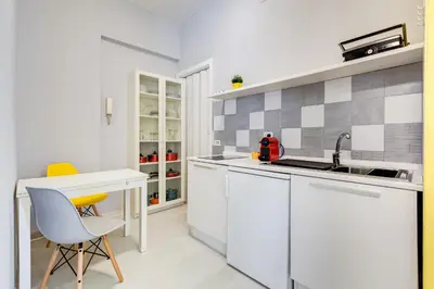 a white kitchen with a sink and a desk at BDC - Kingdom 5-BDR in Termini in Rome