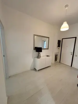 a white room with a mirror and a white dresser at Luca's House - Your perfect Roman hideaway in Rome