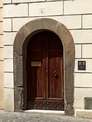 a large wooden door in a brick building at Piazza di Spagna, ground floor, historic center in Rome