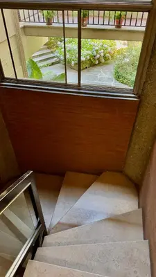 a staircase with a window in a building at Joyful escape flat in Rome