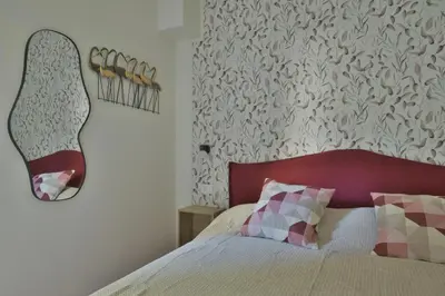 a bedroom with a bed with a red head board at Joyful escape flat in Rome
