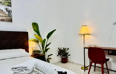 a bedroom with a bed and a desk and a chair at Ayan Guest House in Rome