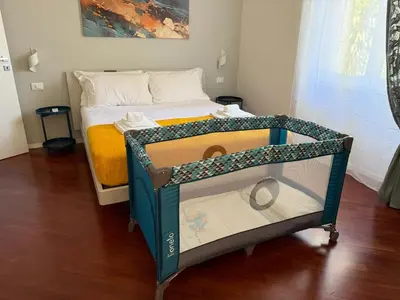 a small bed with a crib in a room at Apartmentdigioia in Rome