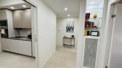 a kitchen with white cabinets and a glass doorway at Apartmentdigioia in Rome