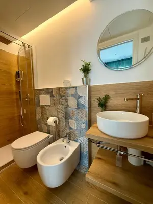 a bathroom with a sink toilet and a mirror at Aurelia Luxury Rome in Rome