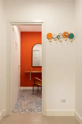 an orange room with a table and a chair at Glory House Trastevere 2 in Rome