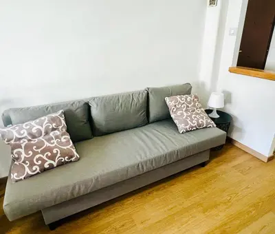 a couch in a living room with two pillows on it at Charming apartment Eur in Rome
