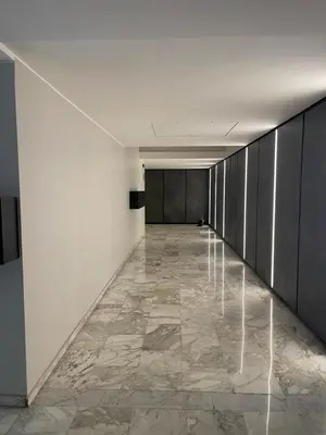 a hallway with white walls and a stone floor at Il Perugino Guest House in Rome