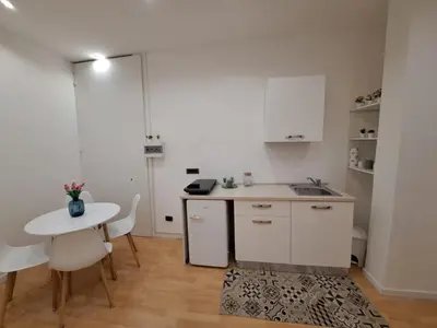 a kitchen with a table and a small table and chairs at TowerMorange in Rome