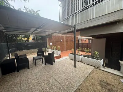 a patio with chairs and tables under a canopy at Grazia s Elegant Roman Haven with Terrace in Rome