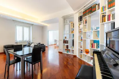 a living room with a table and a piano at Romano Apartments - 