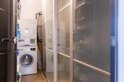 a laundry room with a washer and a washing machine at Romano Apartments - 