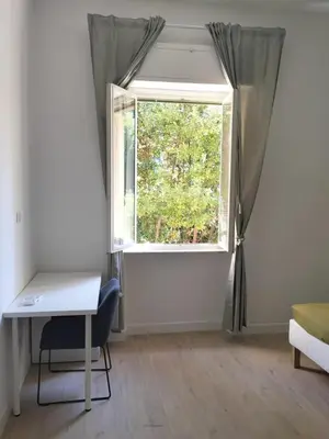 a room with a window with a desk and a chair at Residenza Cimone in Rome