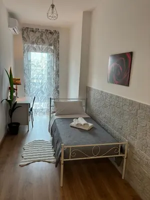 a bedroom with a bed and a table and a window at Inn Rhome 71 in Rome