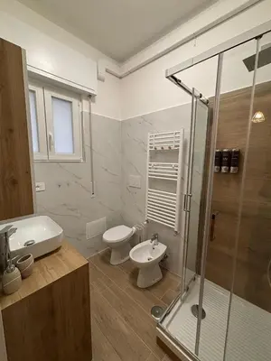 a bathroom with a toilet and a sink and a shower at Inn Rhome 71 in Rome