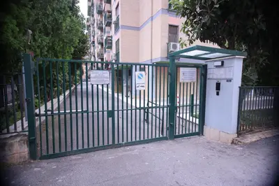 a gate with a sign in front of a building at Inn Rhome 71 in Rome