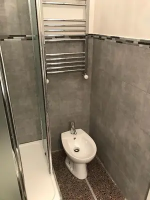 a bathroom with a shower and a toilet and a sink at A Casa Di Giallo B&B in Rome