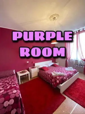 a pink bedroom with a purple room sign on the wall at A Casa Di Giallo B&B in Rome